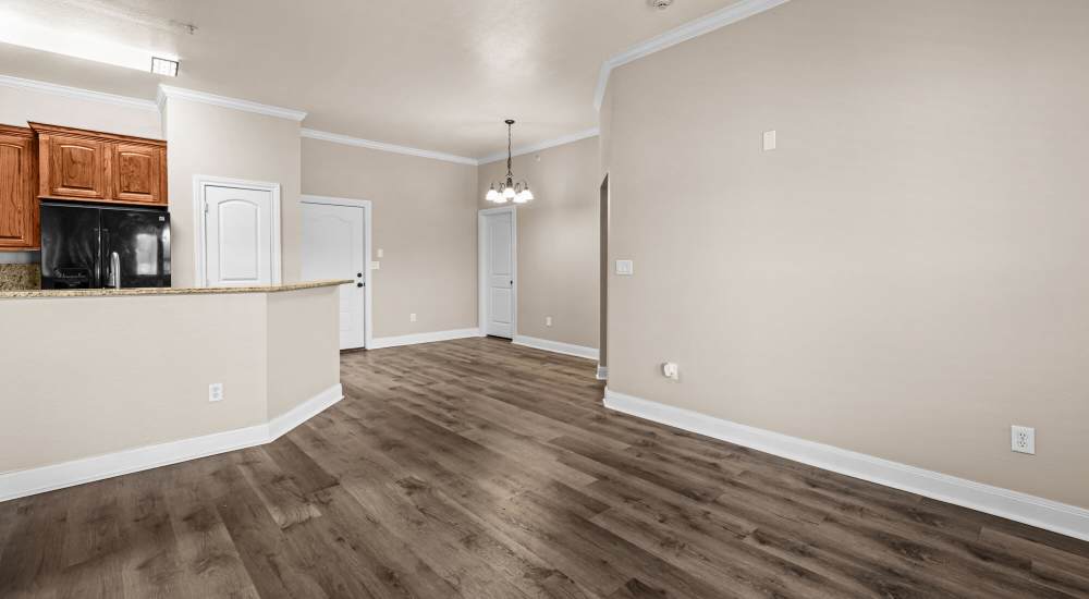 Living area with view of kitchen at The Arbors of Mineola in Mineola, Texas