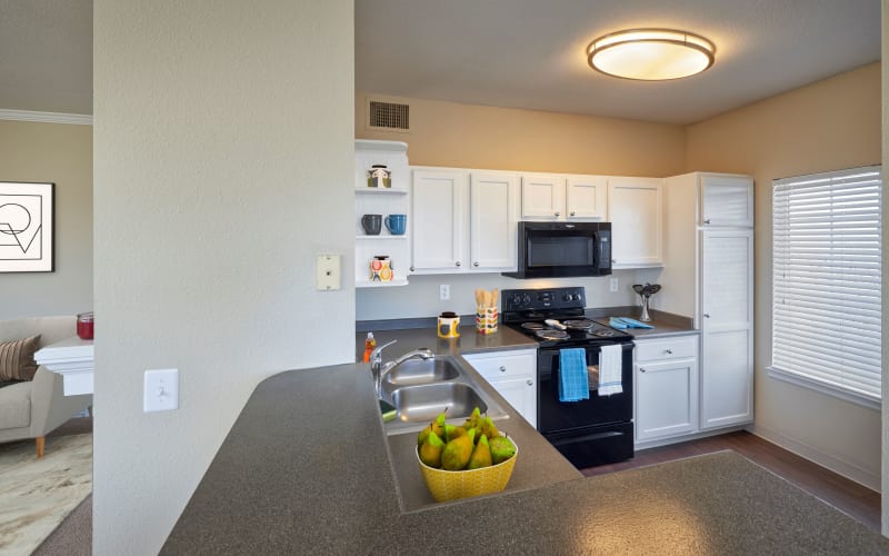 Renovated kitchen with white cabinets at Skyecrest Apartments in Lakewood, Colorado