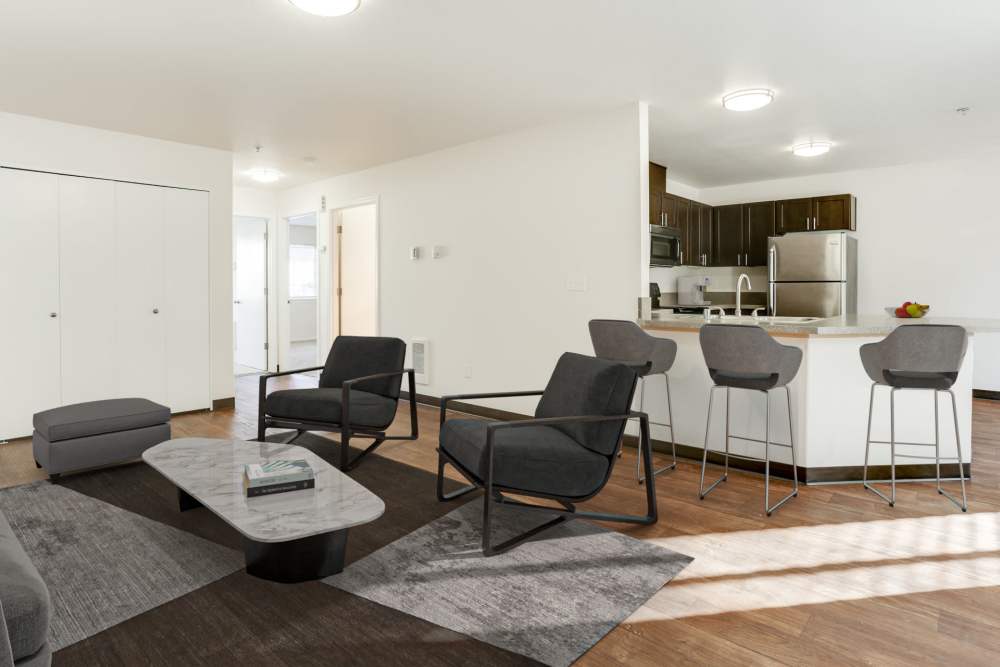View of the kitchen and living room at The Addison Apartments in Vancouver, Washington