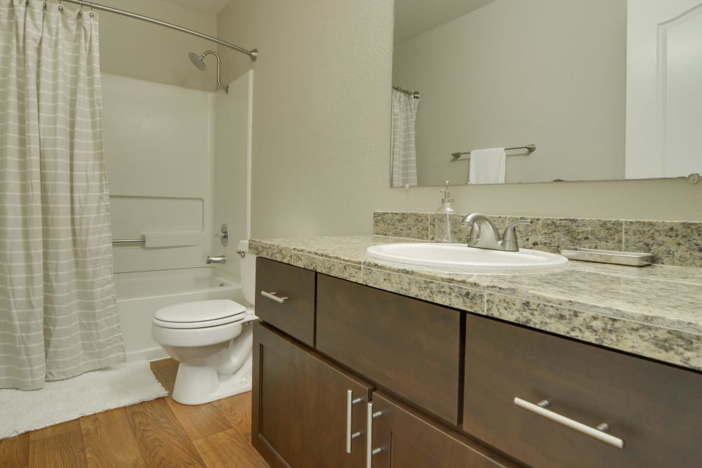 Bathroom with fashionable counter tops and cabinets at Carriage House Apartments in Vancouver, Washington