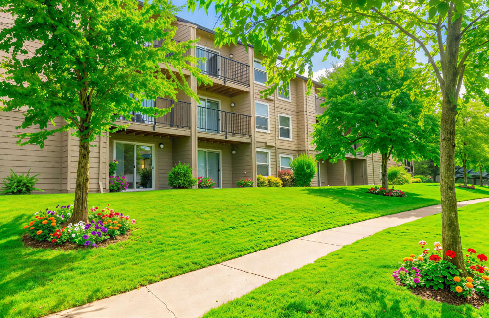 Exterior view of the building with green lawn at Mt. Scott Commons in Happy Valley, Oregon