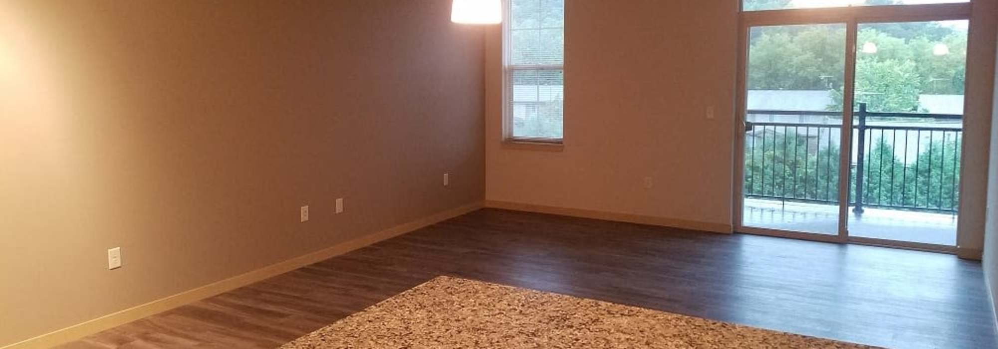 Spacious apartment kitchen extending to the private balcony at Mill Creek Apartments in Cross Plains, Wisconsin