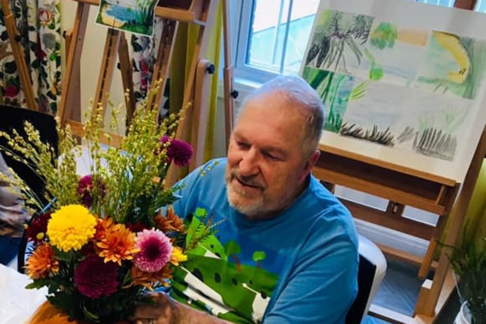 Resident making a flower arrangement at Blossom Ridge in Oakland Charter Township, Michigan