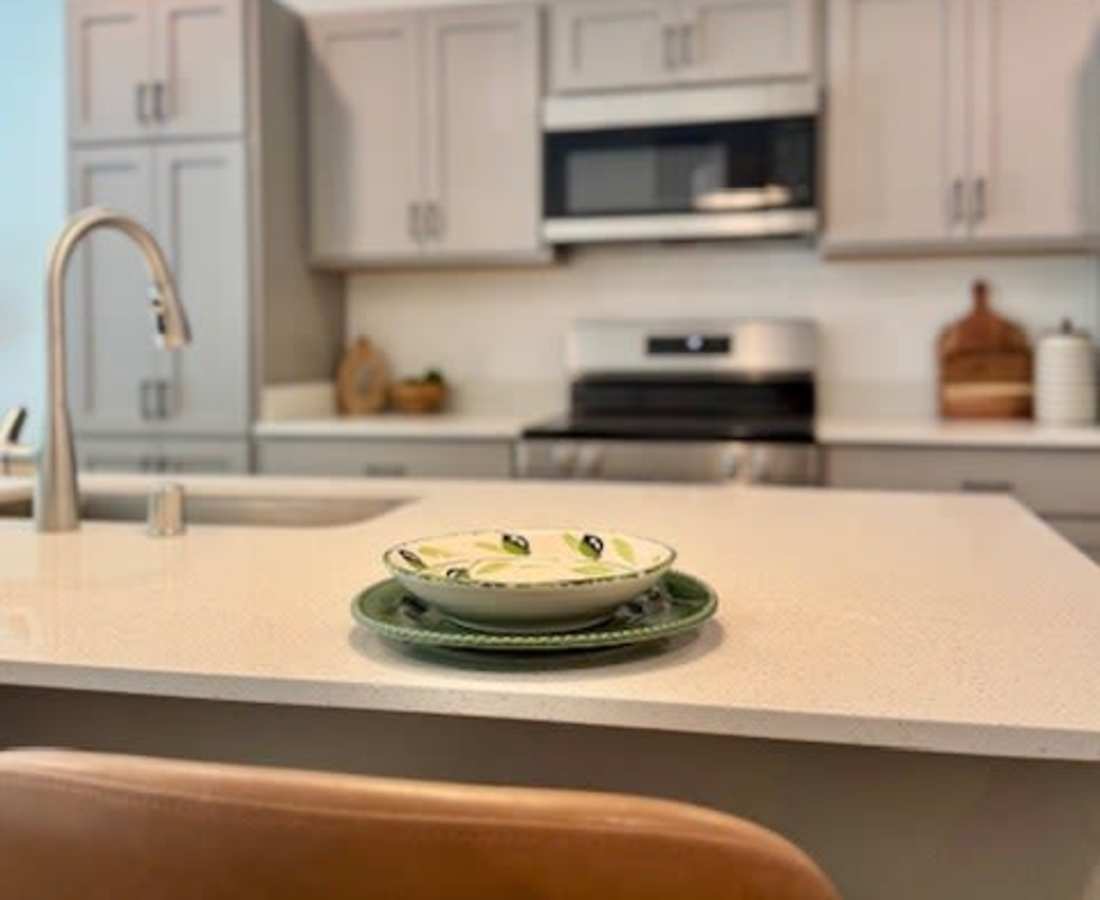 Plates are stacked on a kitchen countertop at Pritchard Park Place in Racine, Wisconsin