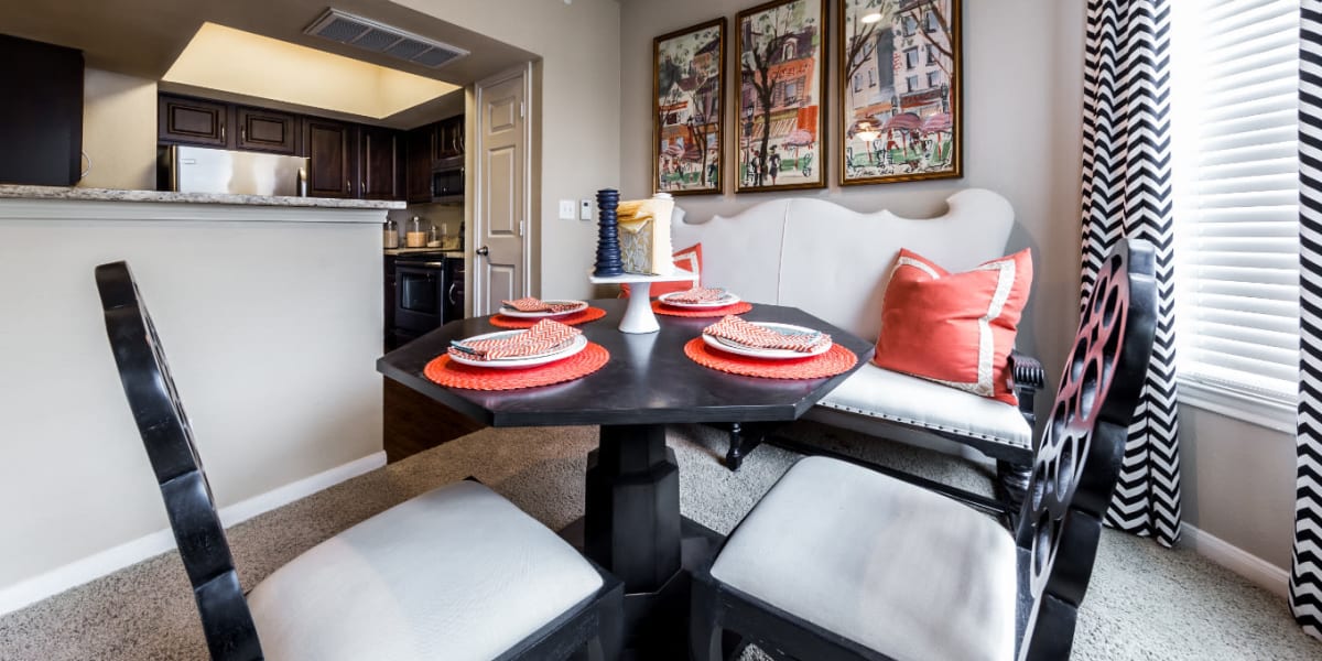 Dining room with large windows overlooking kitchen at Marquis at Stonegate in Fort Worth, Texas