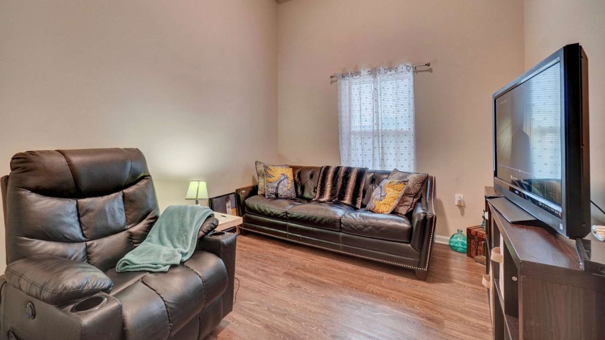 Living room with couch and tv at Holley Pointe in Portsmouth. VA