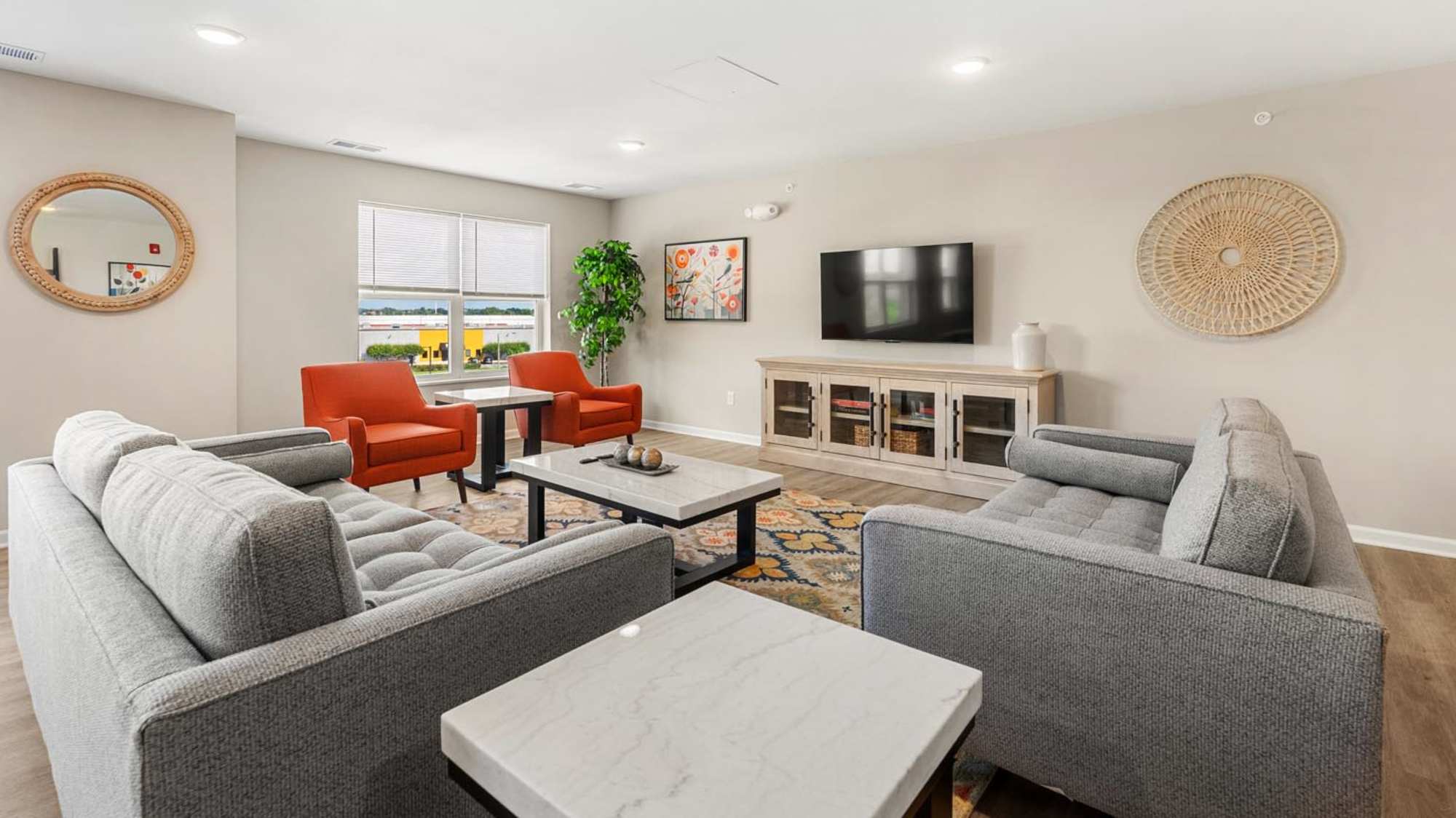 Community room with lounge area at Deville Manor in Oswego, Illinois