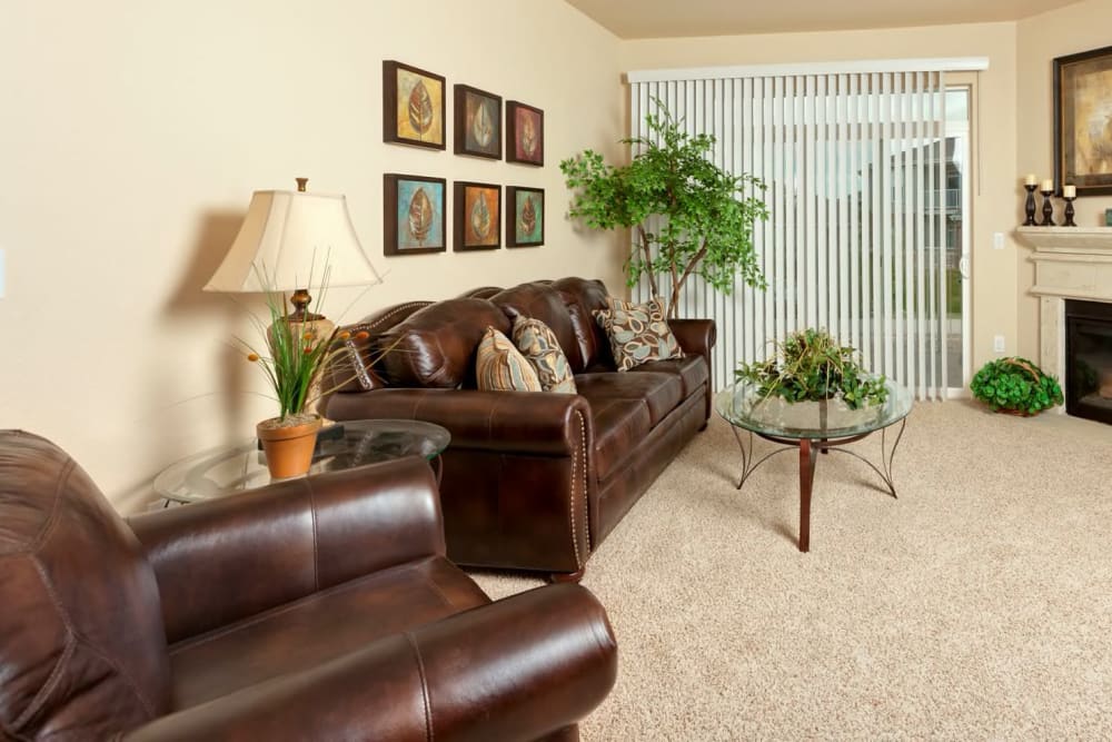 Carpeted living room with fireplace at The Preserve at Greenway Park in Casper, Wyoming