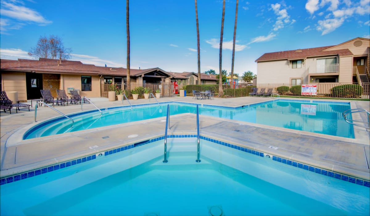 Black couple hanging out by the pool at Oro Vista Villas in San Diego, California