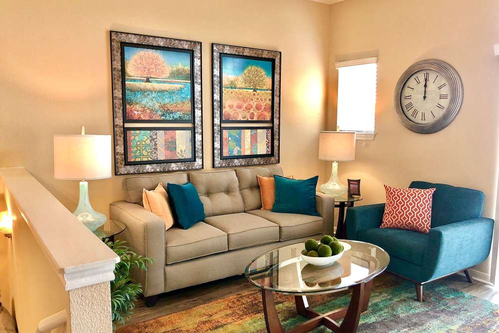  Living room with wood-style flooring at The Abbey at Stone Oak in San Antonio, Texas
