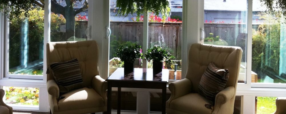 Comfortable seating in the sunroom at at Chateau Gardens Memory Care in Springfield, Oregon