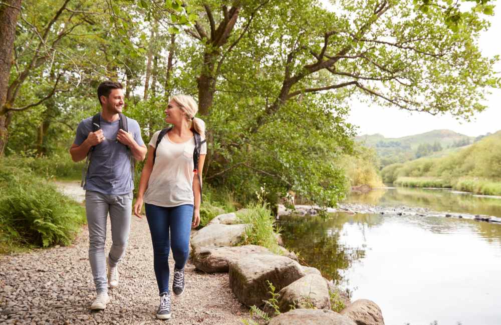 Resident couple walking in park near Falls at Arden in Sacramento, California