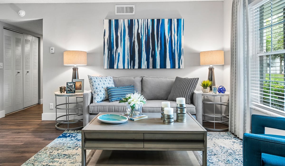 Model living space with blue accents at Boynton Place Apartments in Boynton Beach, Florida