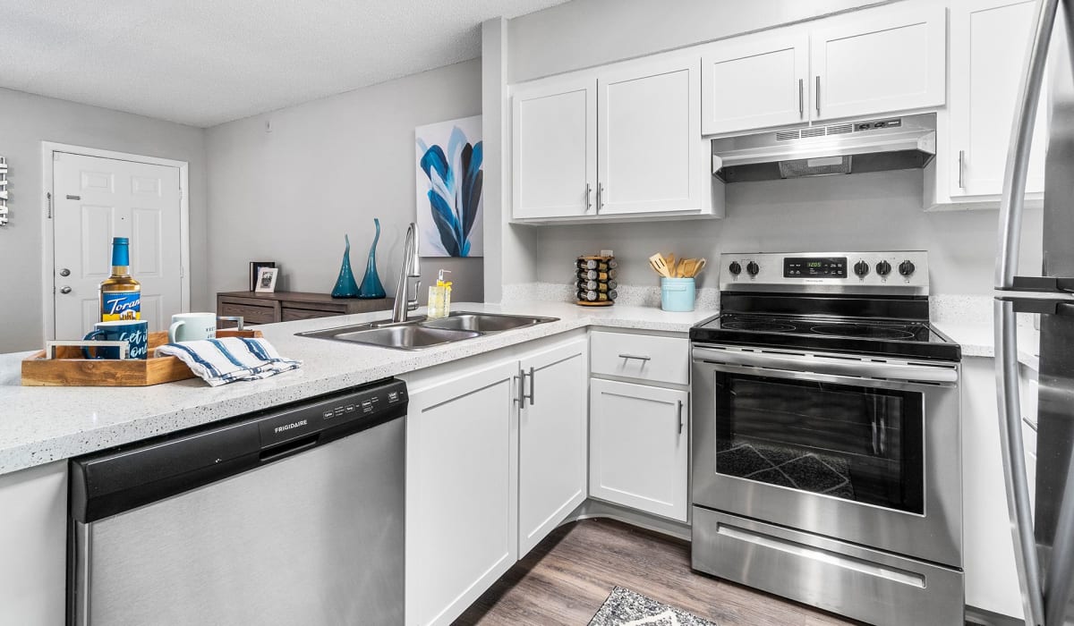 Model kitchen with modern appliances at Boynton Place Apartments in Boynton Beach, Florida