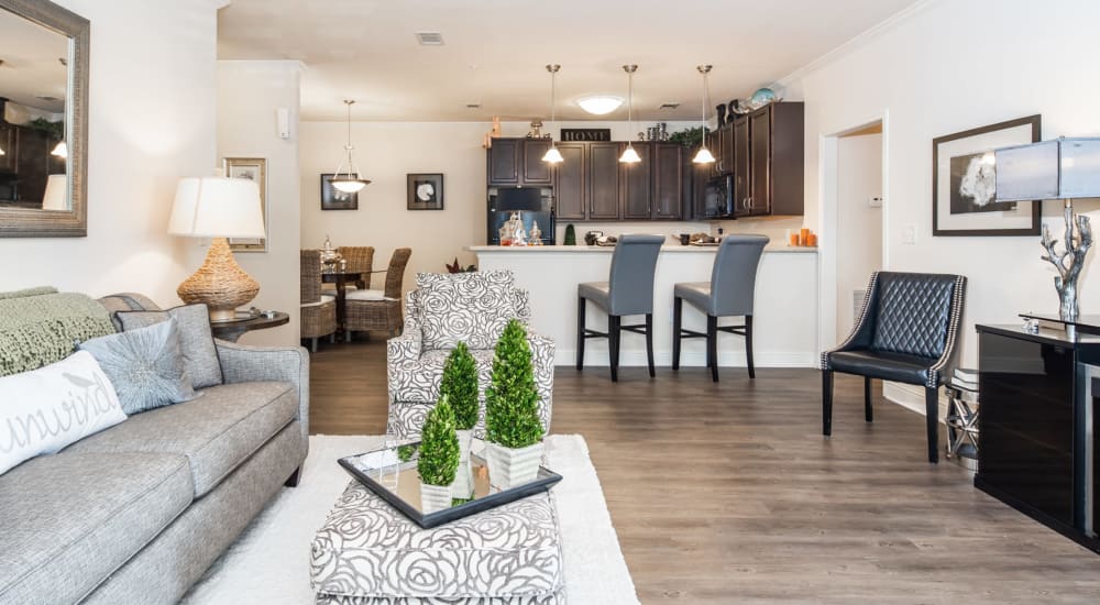 A furnished apartment living room with bar seating in the kitchen at Riverstone in Macon, Georgia