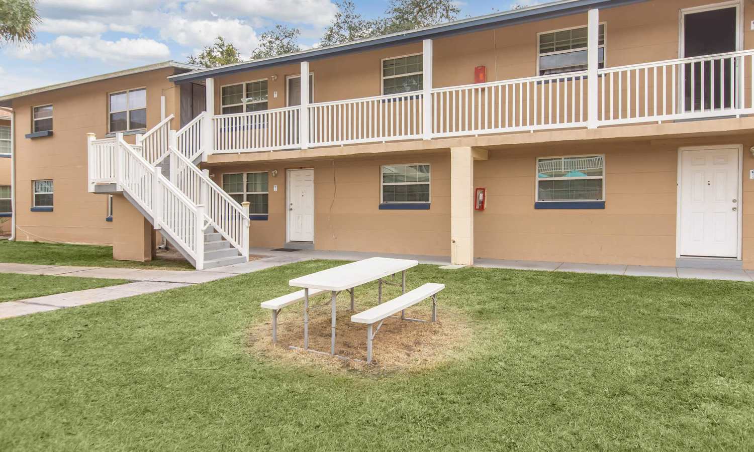 Apartment with seating in lawn at Serenity Apartments in Leesburg, Florida