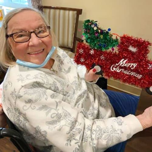 Resident receiving a christmas care package at The Oxford Grand Assisted Living & Memory Care in McKinney, Texas