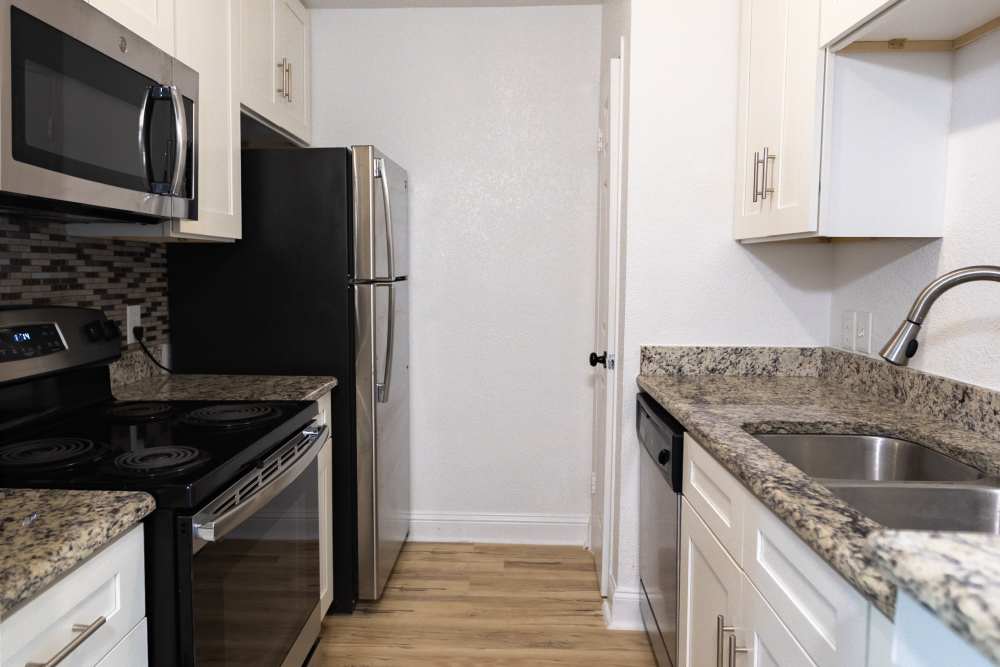 Kitchen with stainless-steel appliances at Lakeshore Villa Apartments in Rowlett,Texas