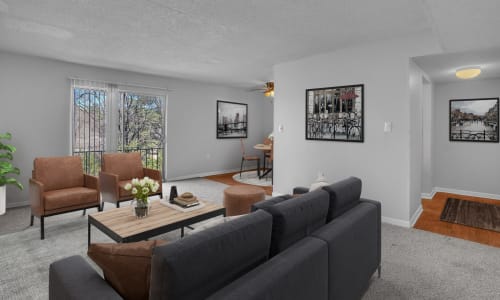 A dining room table and furnished living room at Pine Crest Apartment Homes in North Augusta, South Carolina