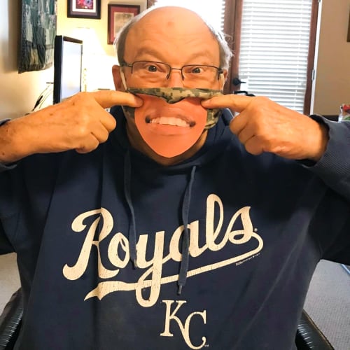 Resident holding up a 'face' styled face mask at The Oxford Grand Assisted Living & Memory Care in Wichita, Kansas