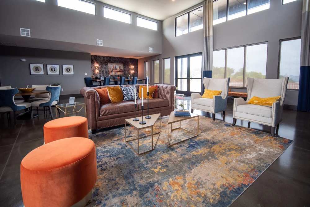 Modern clubhouse lounge at Elevation 800 featuring high ceilings, floor-to-ceiling windows, stylish seating areas, and contemporary décor.