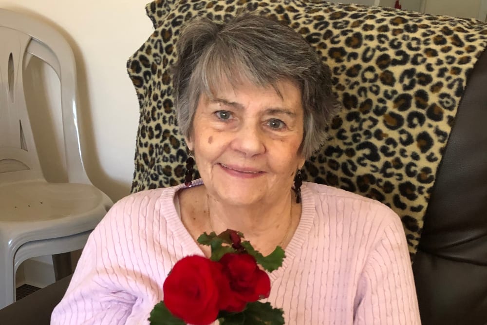 Resident with roses at Traditions of Cross Keys in Glassboro, New Jersey