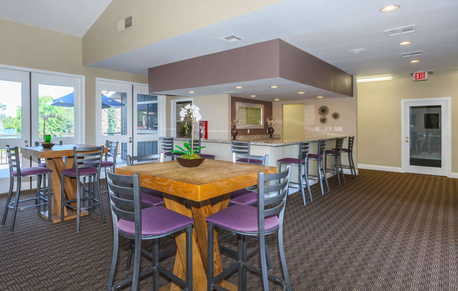 Spacious clubhouse with carpet flooring at Parcwood Apartments in Corona, California, 