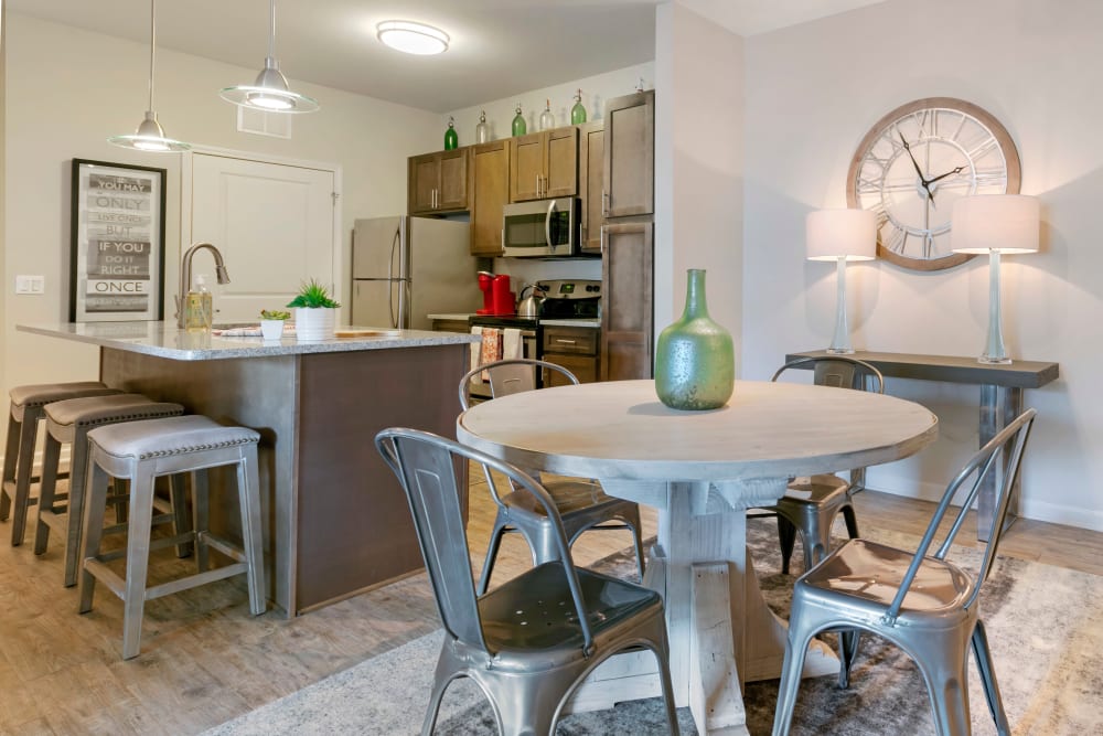 Dining area and modern kitchen with a breakfast bar at The Village at Apison Pike in Ooltewah, Tennessee