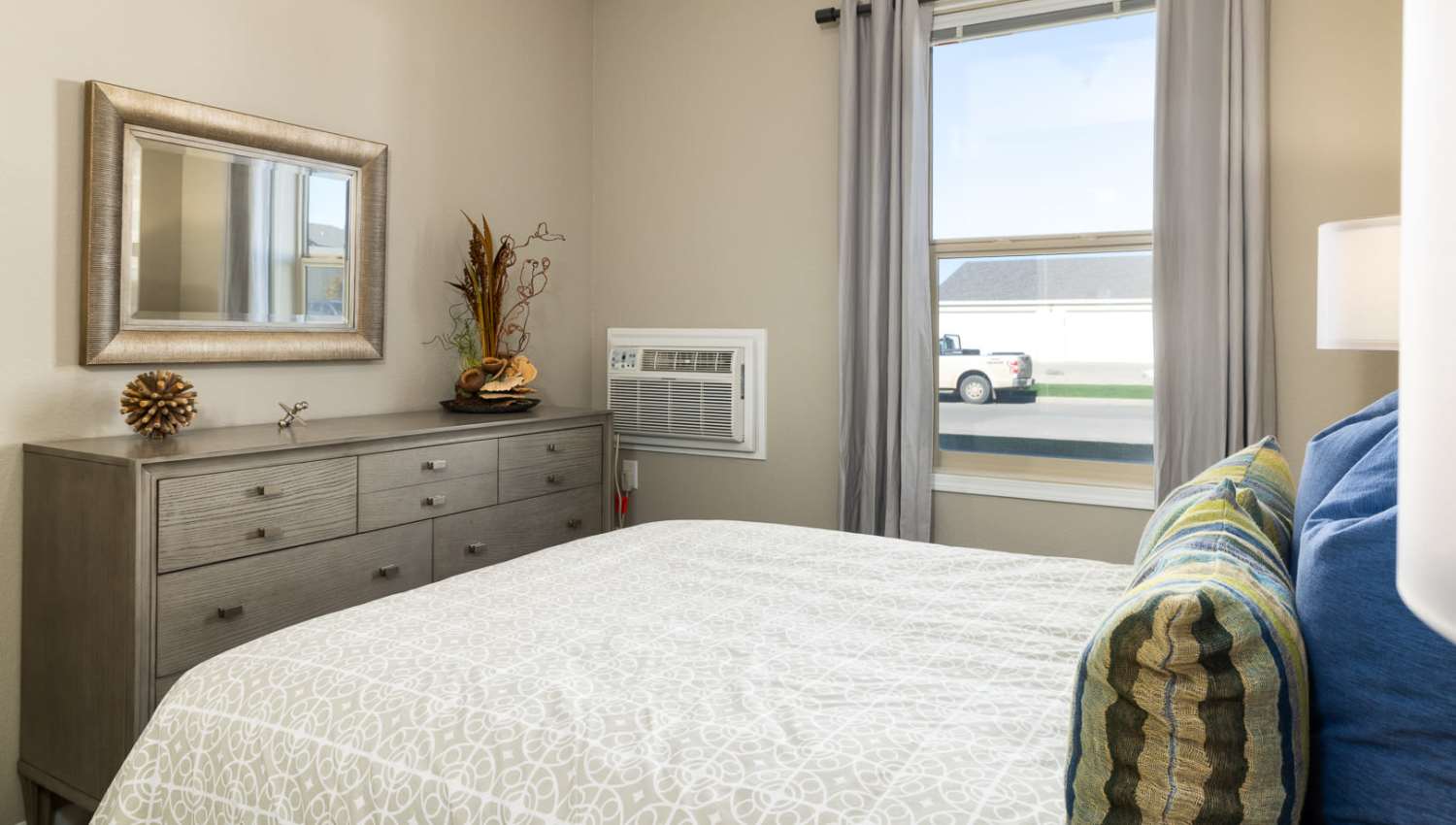 Cozy bedroom with a large bed at University Commons in Williston, North Dakota