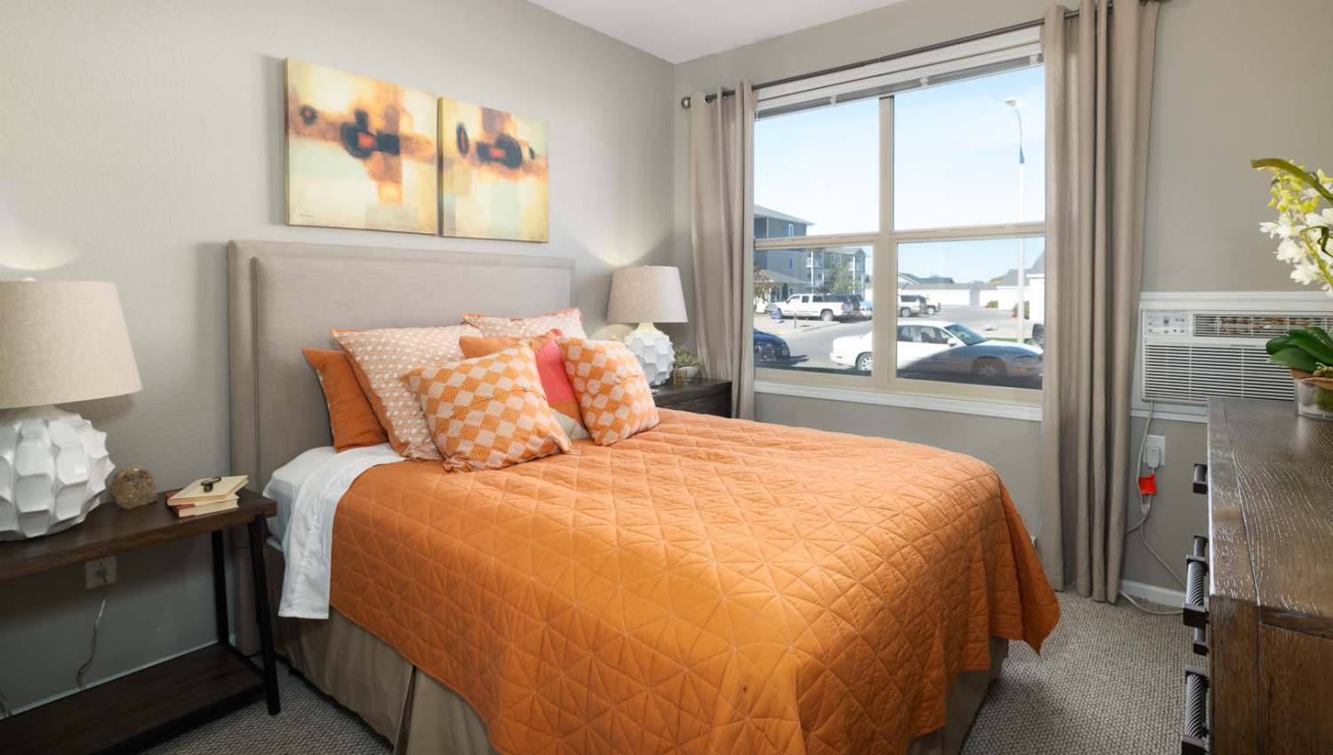 Bedroom with a large bed and windows at University Commons in Williston, North Dakota