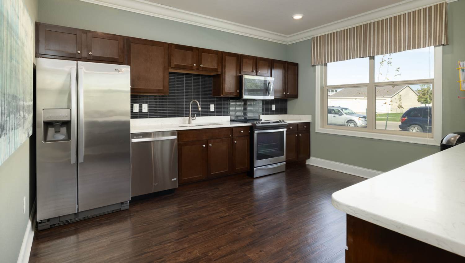 Kitchen with stainless-steel appliances at University Commons in Williston, North Dakota