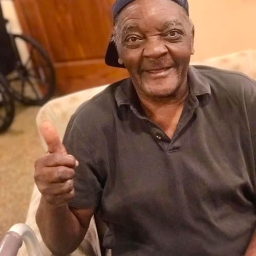 Resident Giving a thumbs up and smiling at Oxford Glen Memory Care at Carrollton in Carrollton, Texas