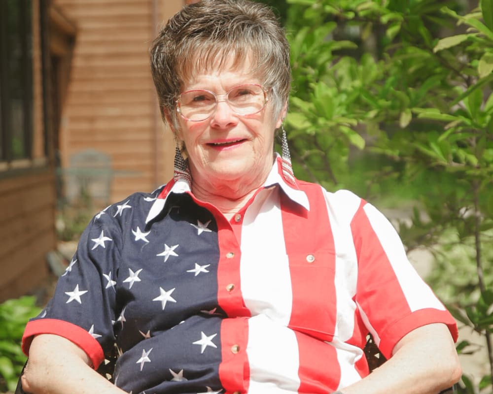 Resident enjoying the sun porch at Garnett Place in Cedar Rapids, Iowa.