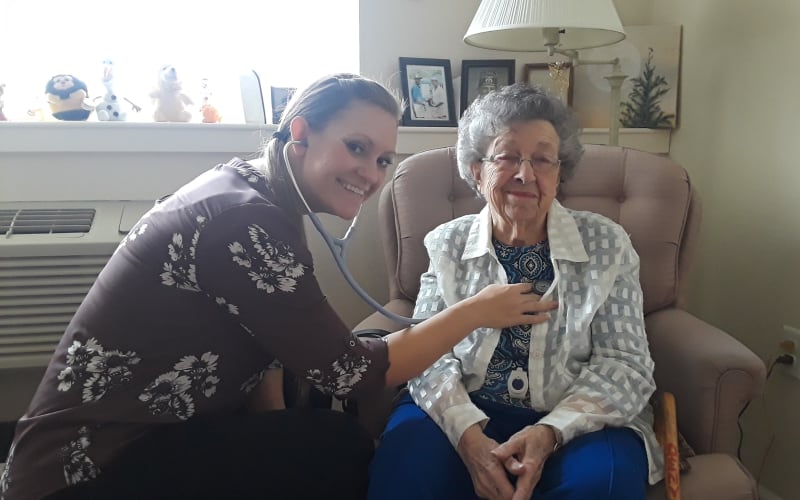 Happy senior woman receiving health care at Eastern Star Masonic Retirement Campus in Denver, CO