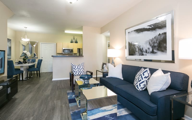 Spacious and bright living room, dining room and kitchen at Crestone Apartments in Aurora, Colorado