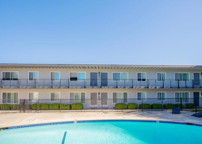 Outdoor swimming pool https://res.cloudinary.com/g5-assets-cld/image/upload/x_0,y_165,h_3654,w_5115,c_crop/q_auto,f_auto,fl_lossy,g_center,h_500,w_700/g5/g5-c-5hqzbvbxv-rutherford-management-company-sd/g5-cl-1orup8jbq2-rutherford-management-company-mountain-view-ca/uploads/Station_EXT6_d3j89p.jpg