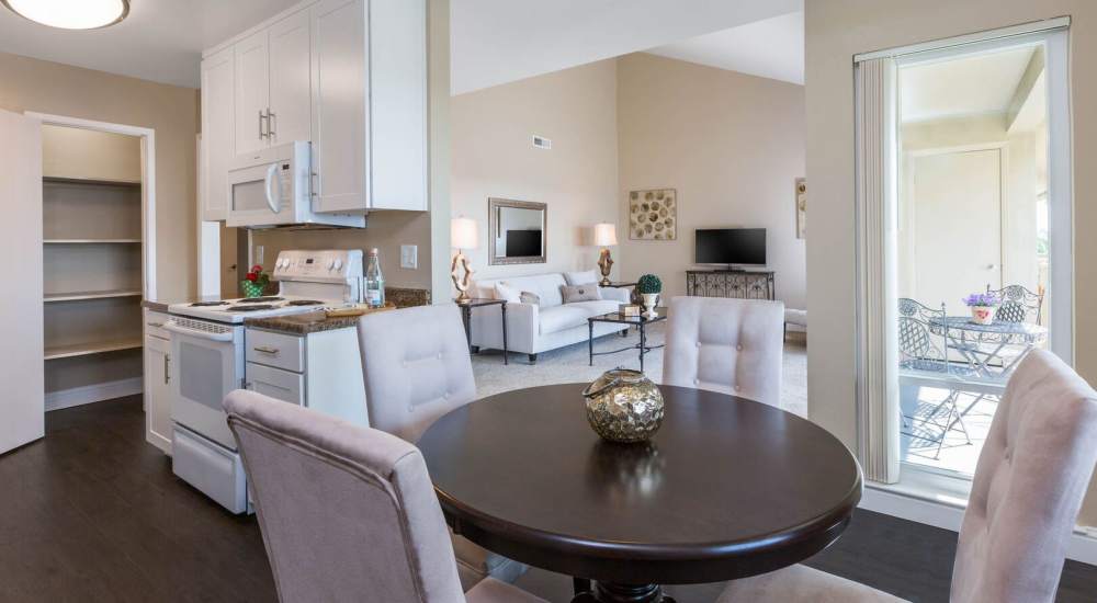 Leather couch and a comfortable chair in a model home's living space at Crestview Terrace in Hayward, California