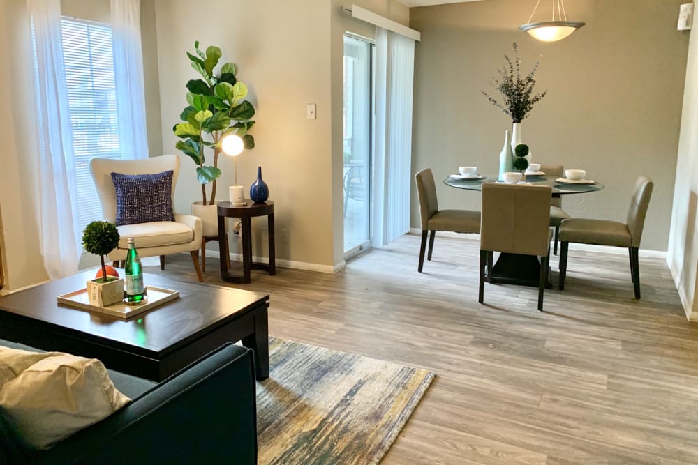Living room with dining space at Oak Ridge Apartments in San Antonio, Texas