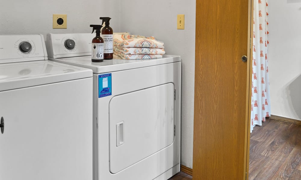 Spacious and clean model bathroom with washer and dryer at Huntington Park Apartments in Wichita, Kansas