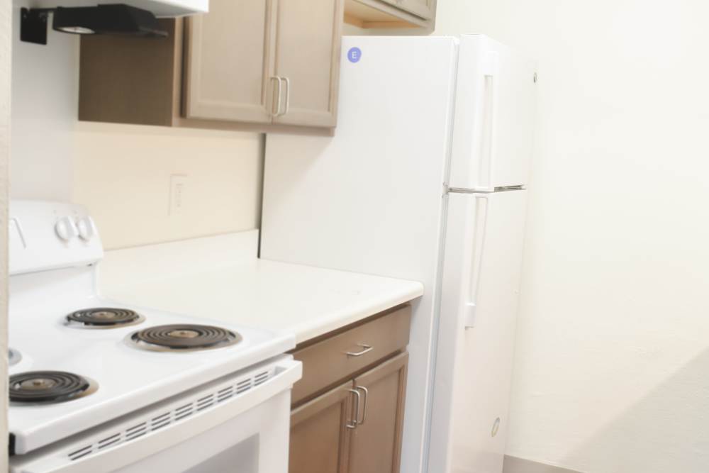 A refrigerator and stove in an apartment kitchen at Clairewood Apartments in Saint Clair, Michigan