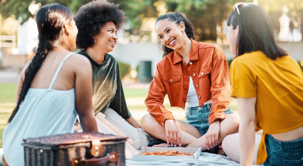 Residents eating pizza in the park near Archer at Brookhill in Charlottesville, Virginia