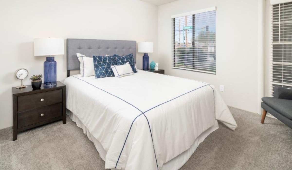 Modern bedroom with window and side lamp at Sunpointe in Phoenix, Arizona