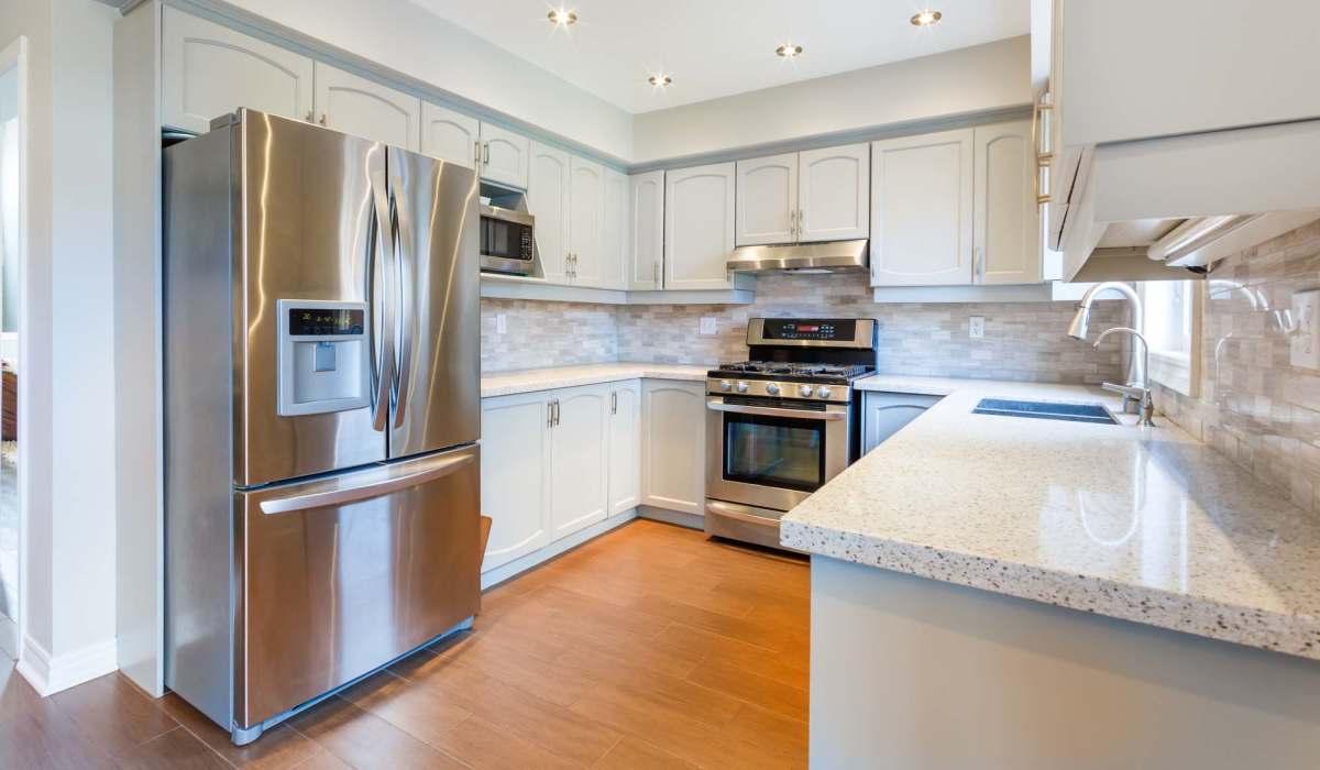 Modern kitchen featuring sleek stainless steel appliances and elegant granite countertops at Lake Pointe Apartments in Madison, Wisconsin.