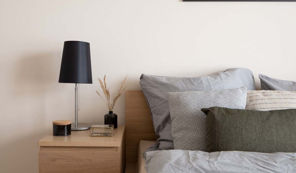 Serene bedroom retreat featuring plush bedding and stylish bedside accents at Loop Commons in Lafayette, Louisiana.
