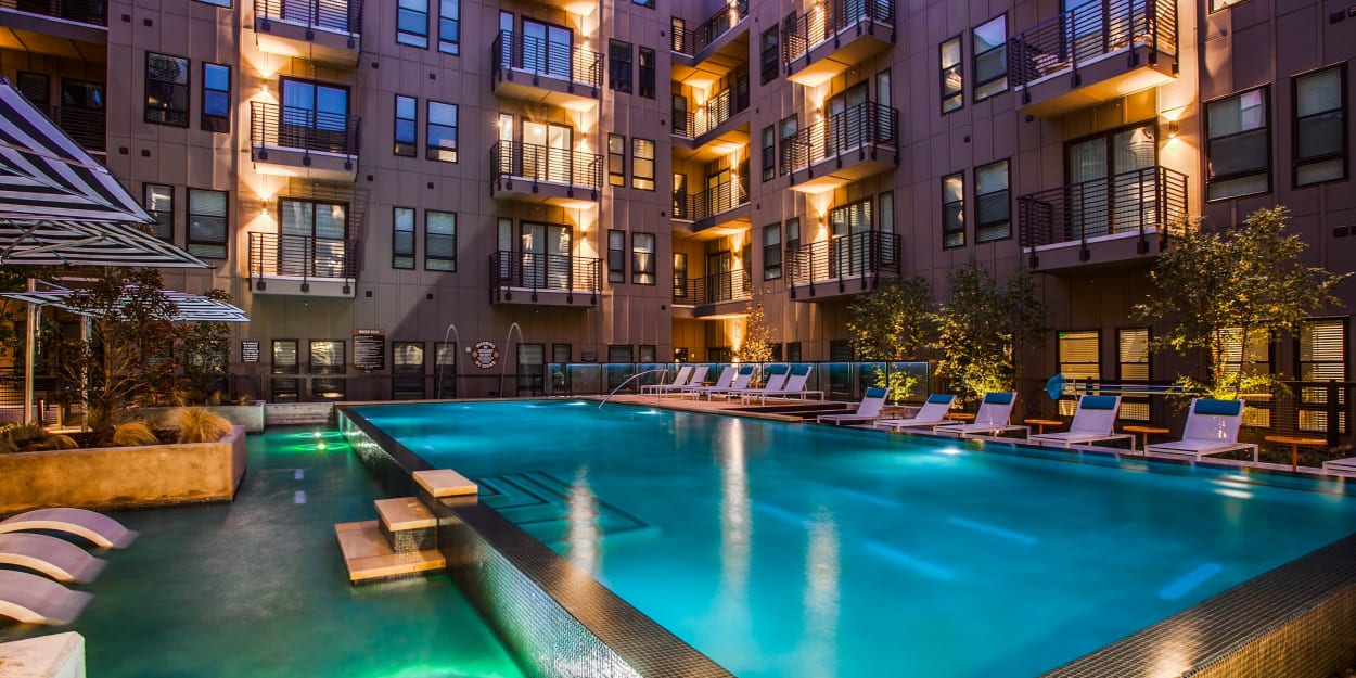 Swimming pool lit up at night The Cooper, Fort Worth, Texas