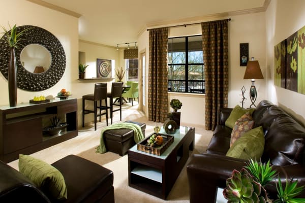 Spacious living room layout with autumn-toned furniture at Las Colinas at Black Canyon in Phoenix, Arizona
