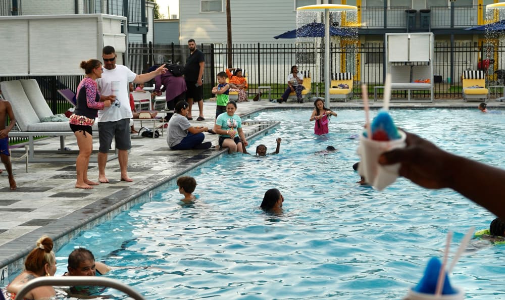 Residents enjoying the pool at Summerfield Apartment Homes in Harvey, Louisiana