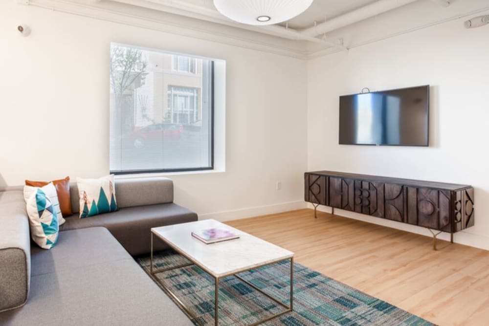 Model living area with wood-style flooring at K Street Flats Apartment Homes in Berkeley, California