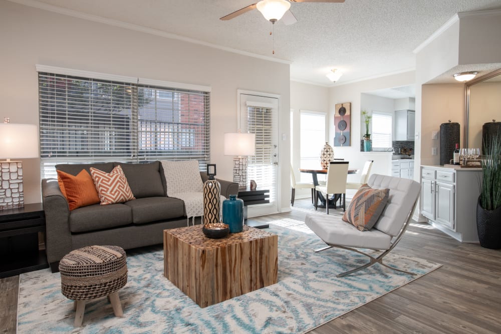 Modern living area with sofas and wooden coffee table at Copper Chase in Arlington, Texas
