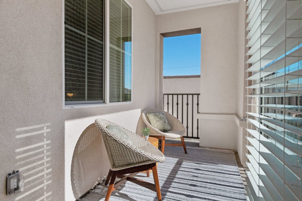 Patio furniture on a private balcony at Alivia Townhomes in Whittier, California